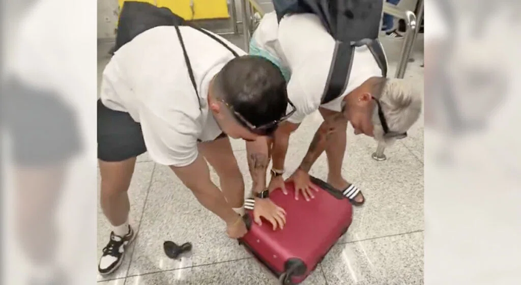 Passenger pulling off wheels from carry-on